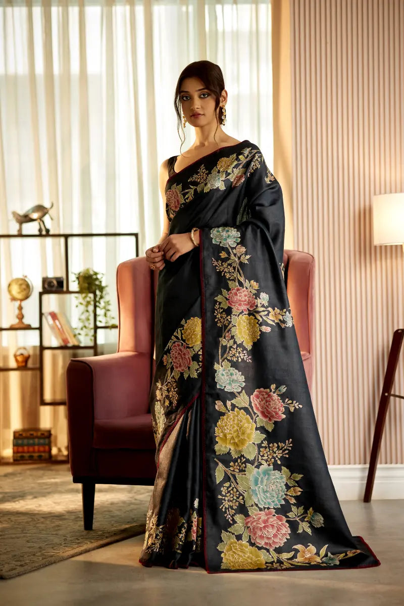 A woman poses in a greyish black tussar silk saree with an unstitched blouse from BenzerWorld ethnicwear store.