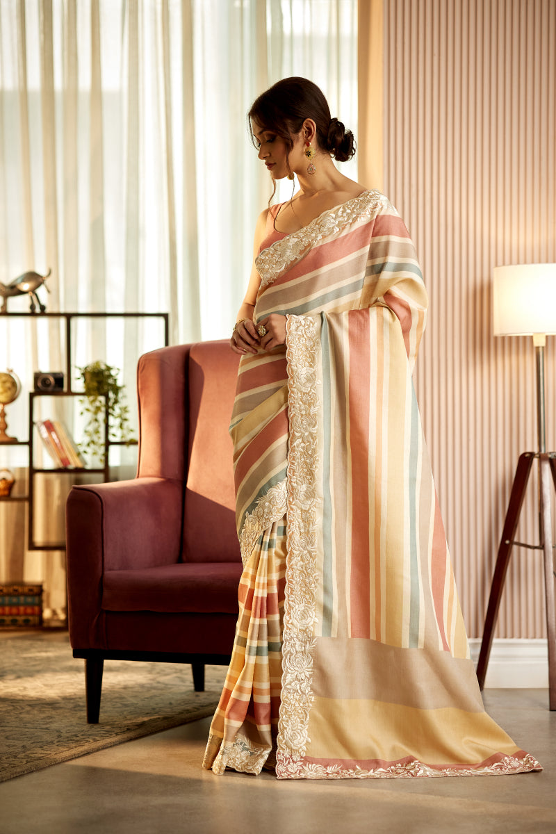 A woman poses in a lehariya tussur silk parsi embroidered saree with an unstitched blouse from BenzerWorld ethnicwear store.