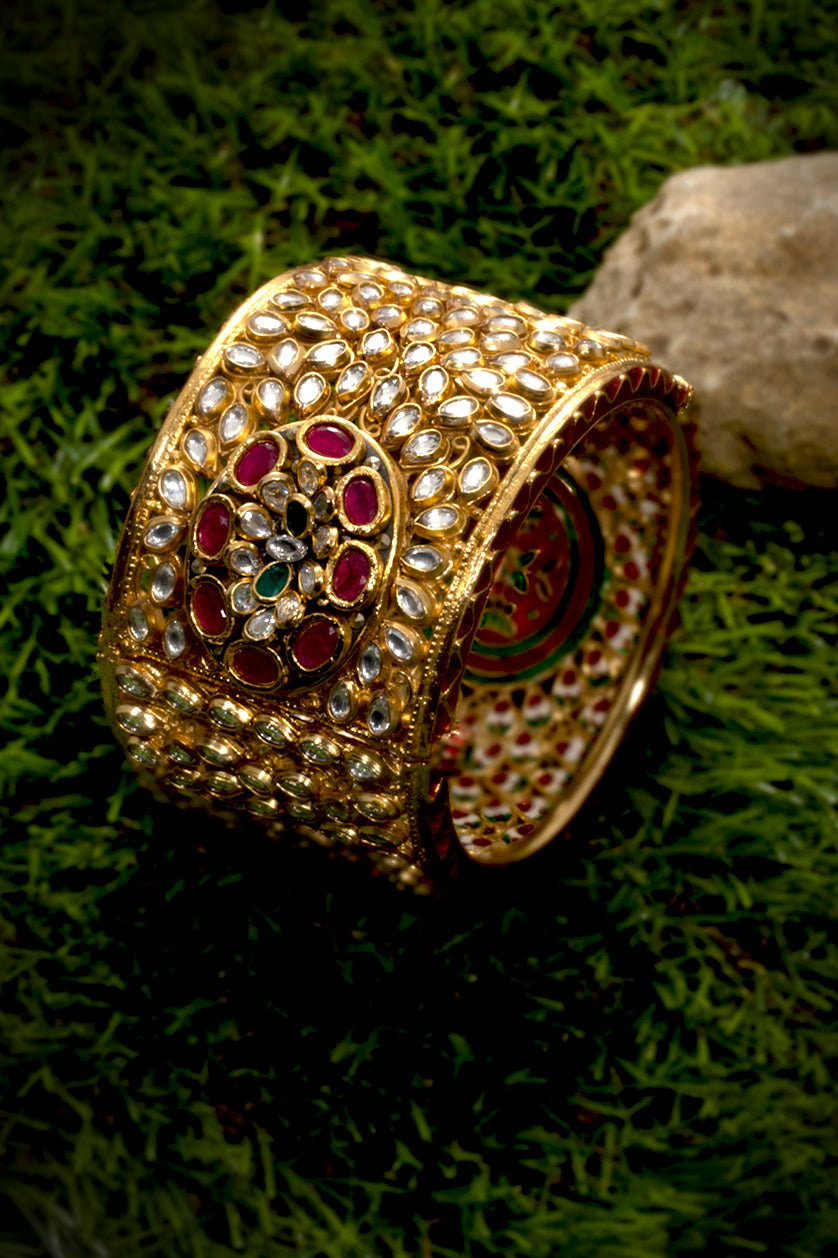 A closeup of a jadau kada with meenakari work from BenzerWorld ethnicwear store.