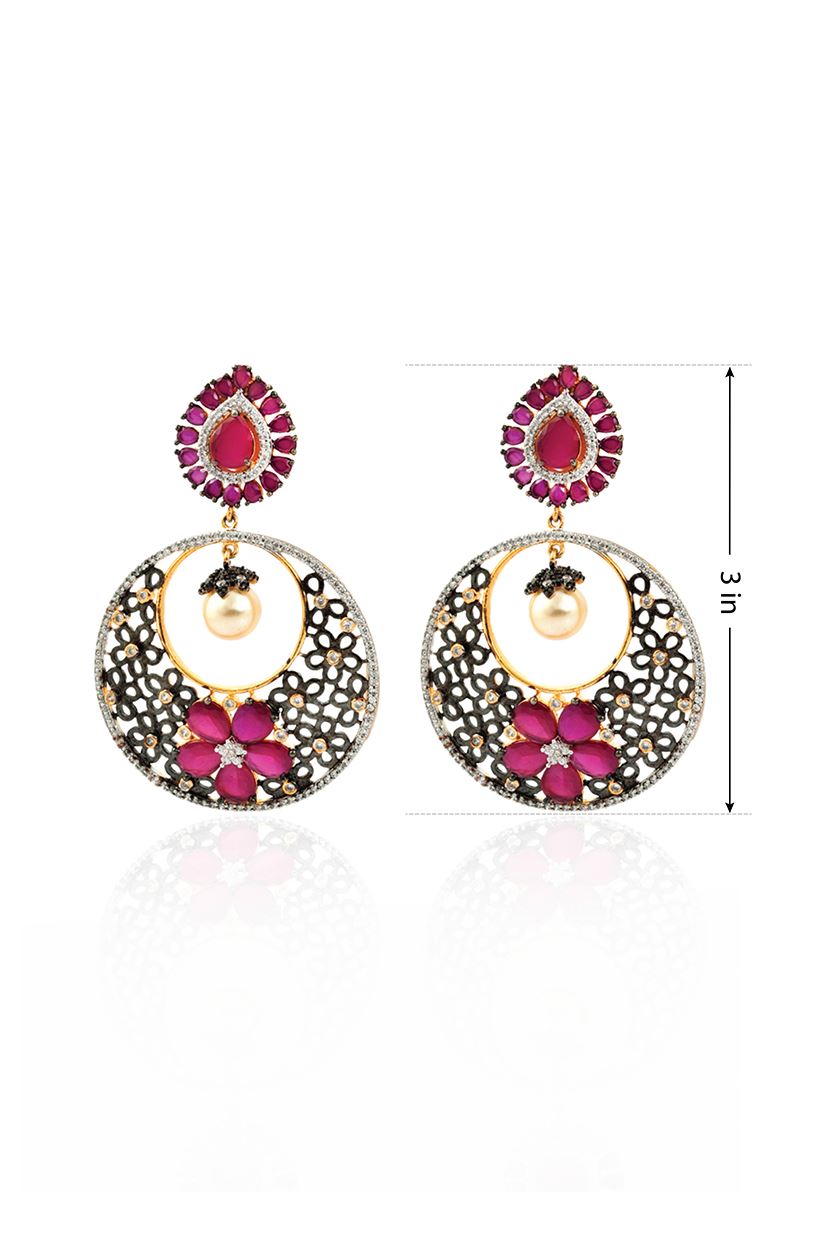 A closeup of American diamond earrings in coloured stone from BenzerWorld ethnicwear store.