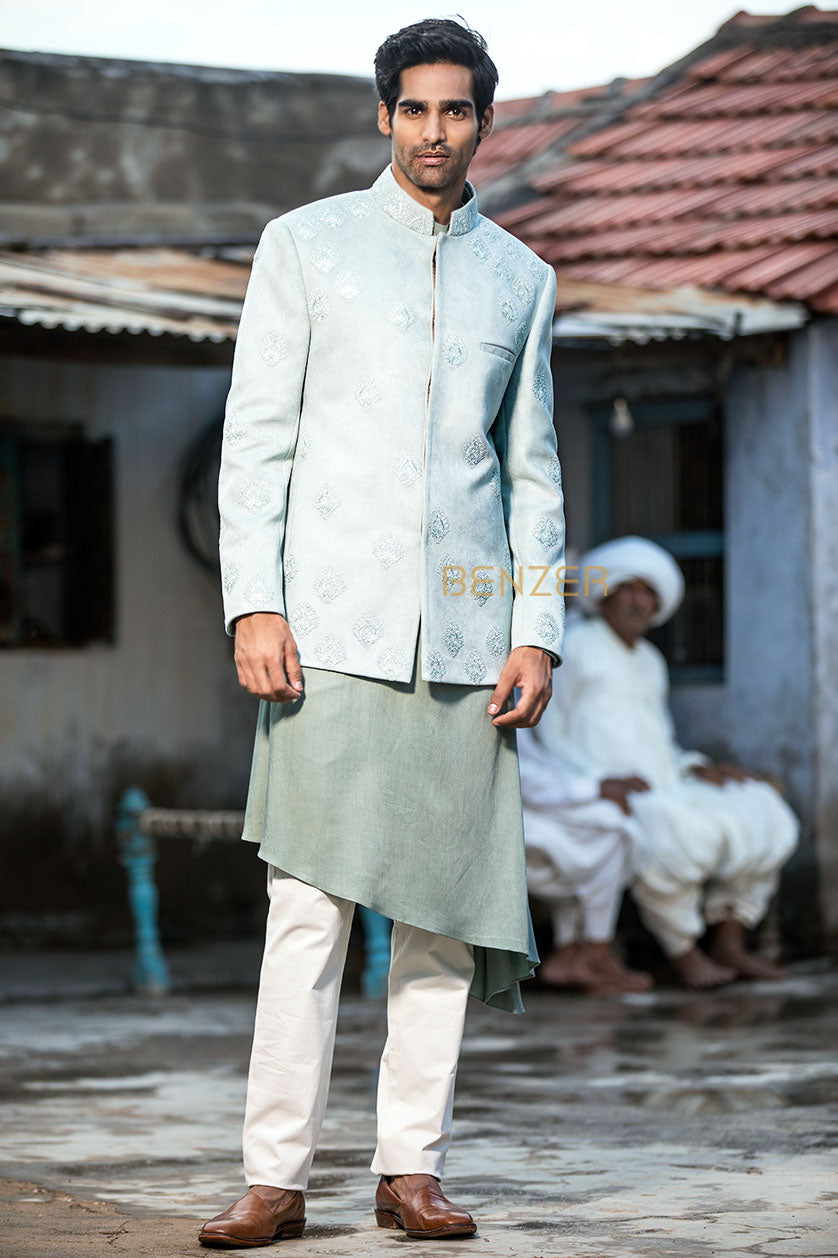 A man poses in an aqua green silk cocktail outfit from BenzerWorld ethnicwear store.