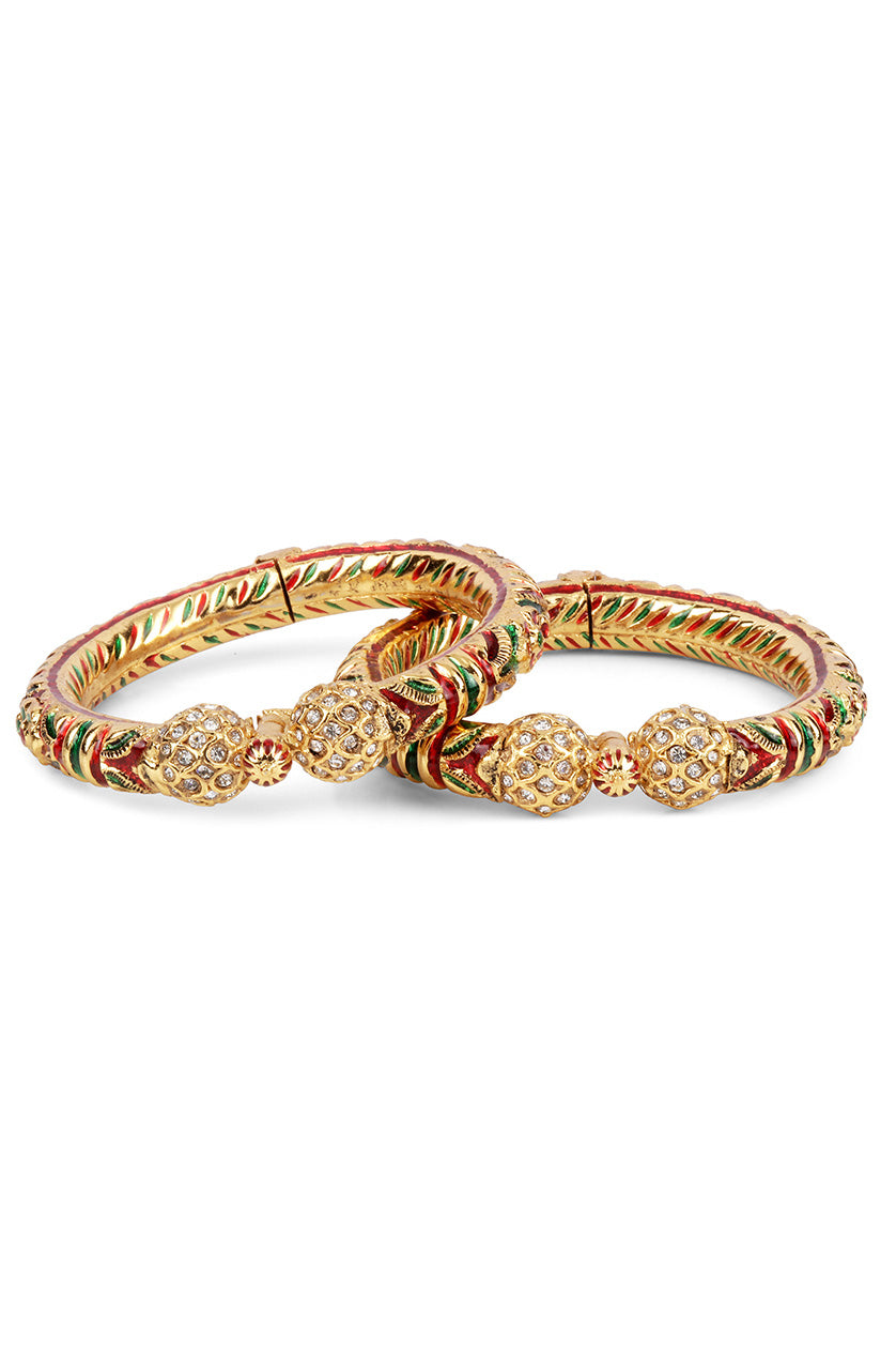 A closeup of bangles in green meenakari work from BenzerWorld ethnicwear store.