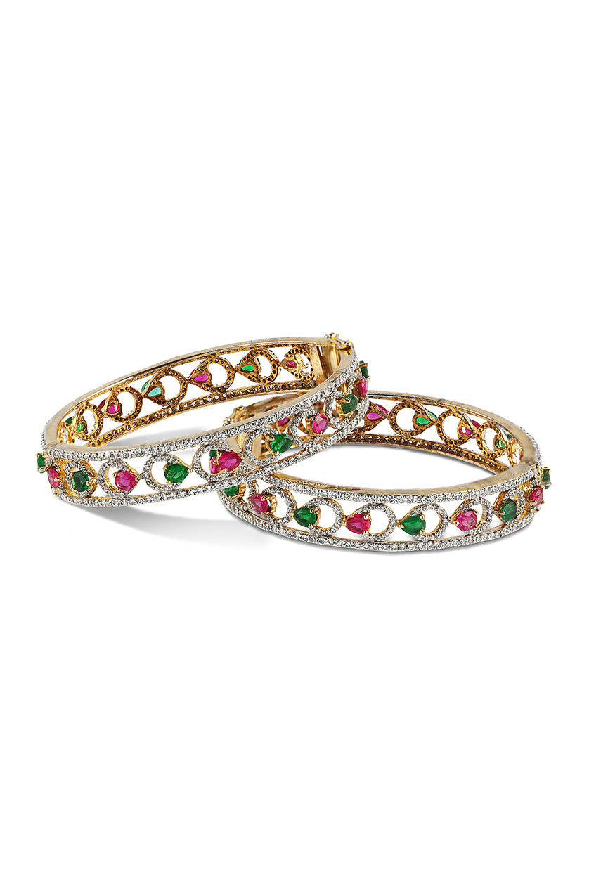 A closeup of bangles with red and green stones from BenzerWorld ethnicwear store.