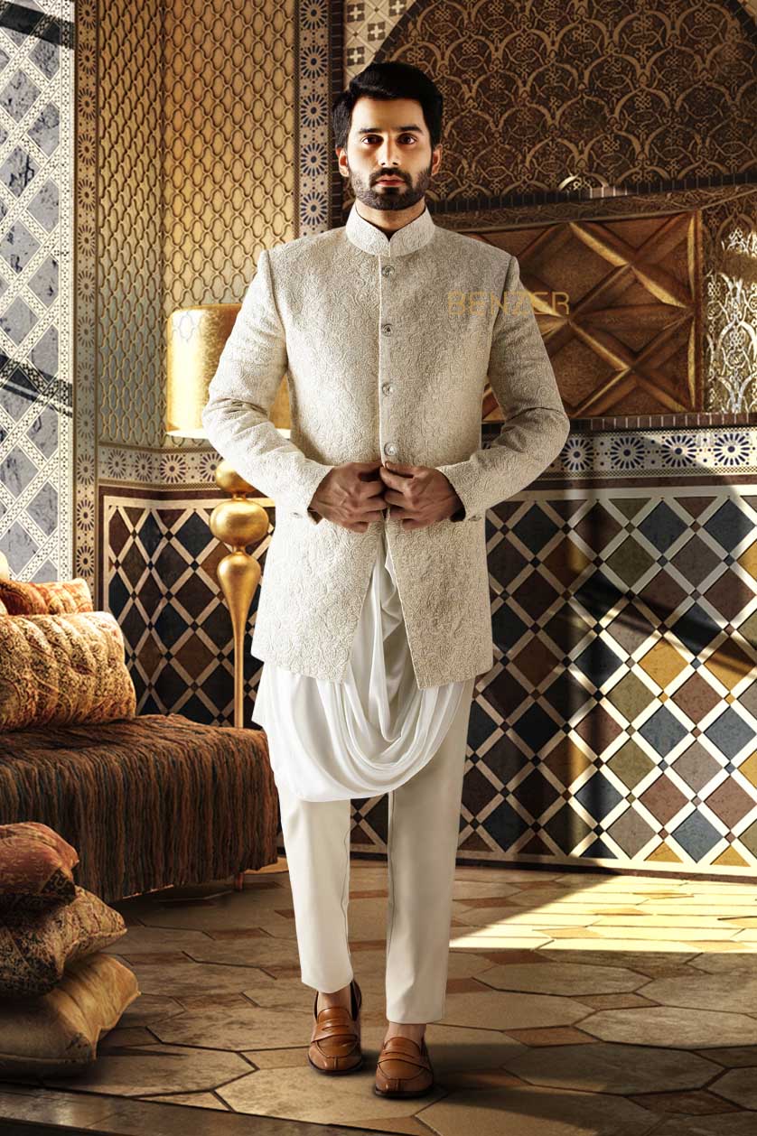 A man poses in a beige silk cocktail outfit from BenzerWorld ethnicwear store.