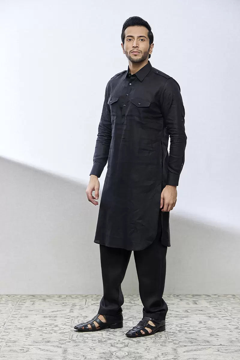 A man in a black linen kurta set from BenzerWorld ethnicwear store poses.