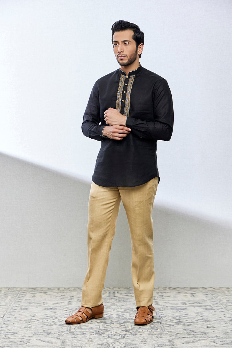 A man poses in a black linen shirt from BenzerWorld ethnicwear store.