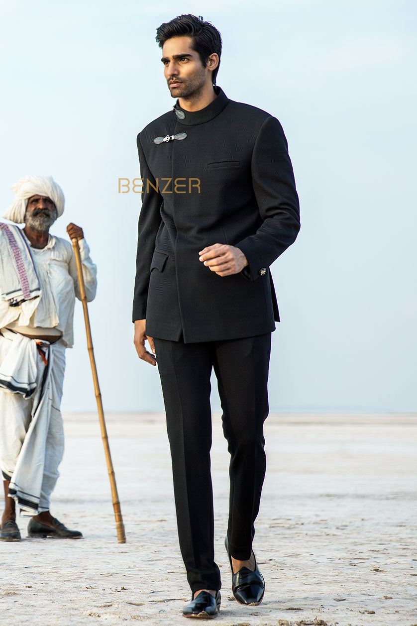 A man poses in a black terrywool drape bandgala from BenzerWorld ethnicwear store.