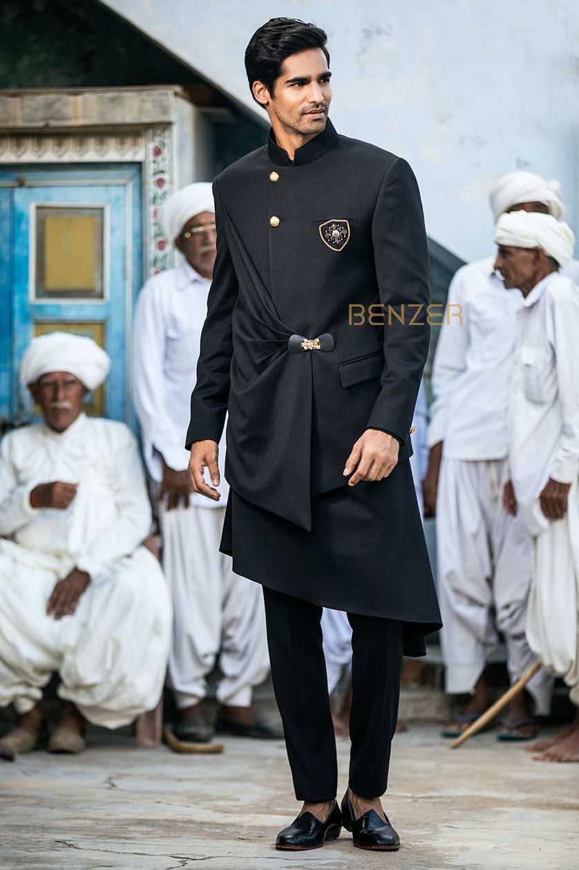 A man poses in a black terrywool sangeet outfit from BenzerWorld ethnicwear store.