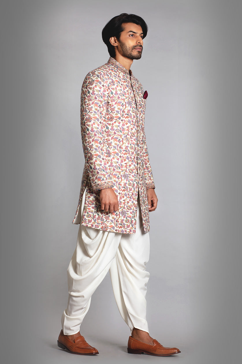 A man poses in a cream pashmina cocktail outfit from BenzerWorld ethnicwear store.