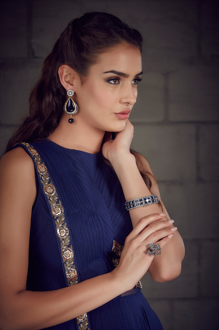 A closeup of cubic zircon earrings from BenzerWorld ethnicwear store.