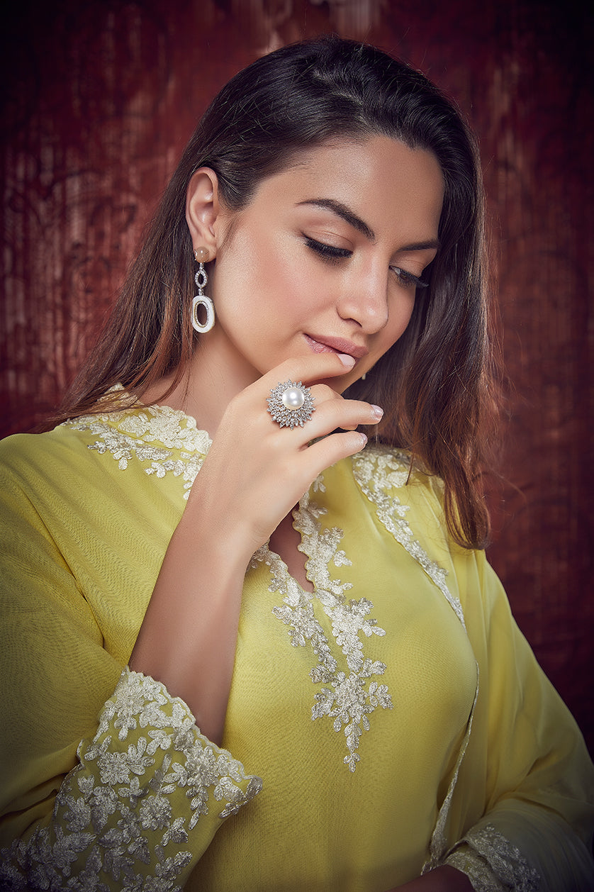 A closeup of cubic zircon earrings with ruby stones from BenzerWorld ethnicwear store.