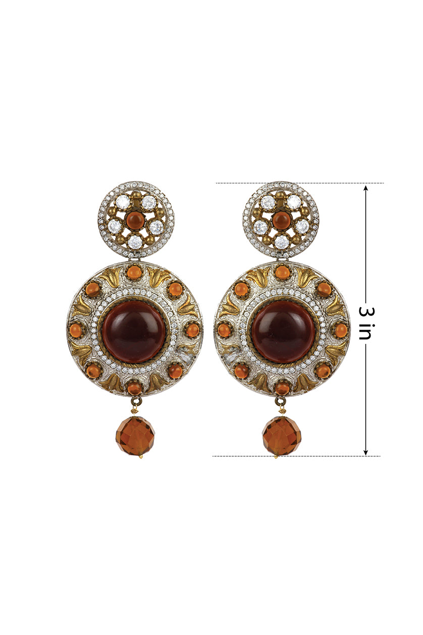 A closeup of cubic zirconia and golden stones round earrings from BenzerWorld ethnicwear store.