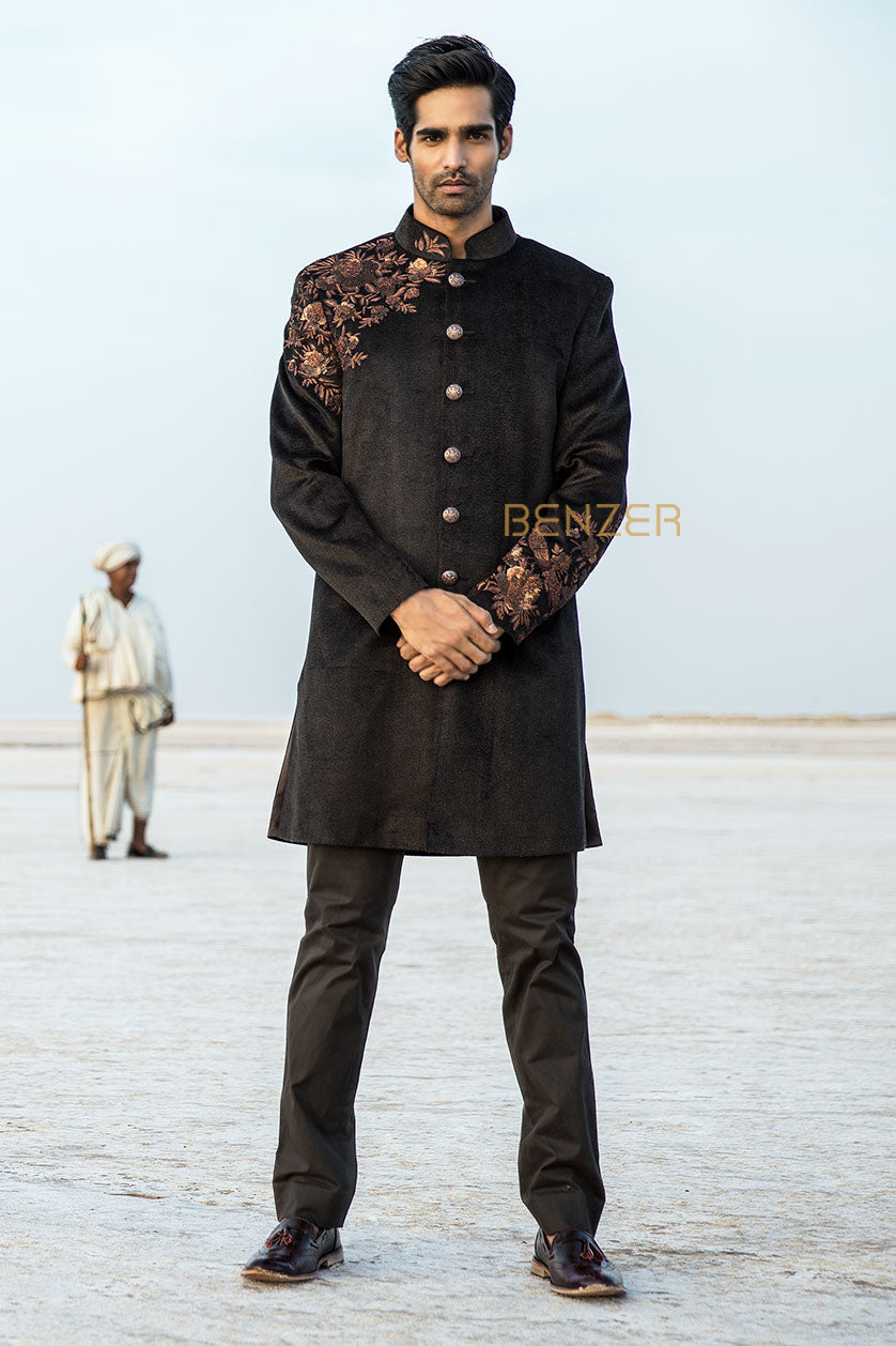 A man poses in a dark brown jute sangeet outfit from BenzerWorld ethnicwear store.