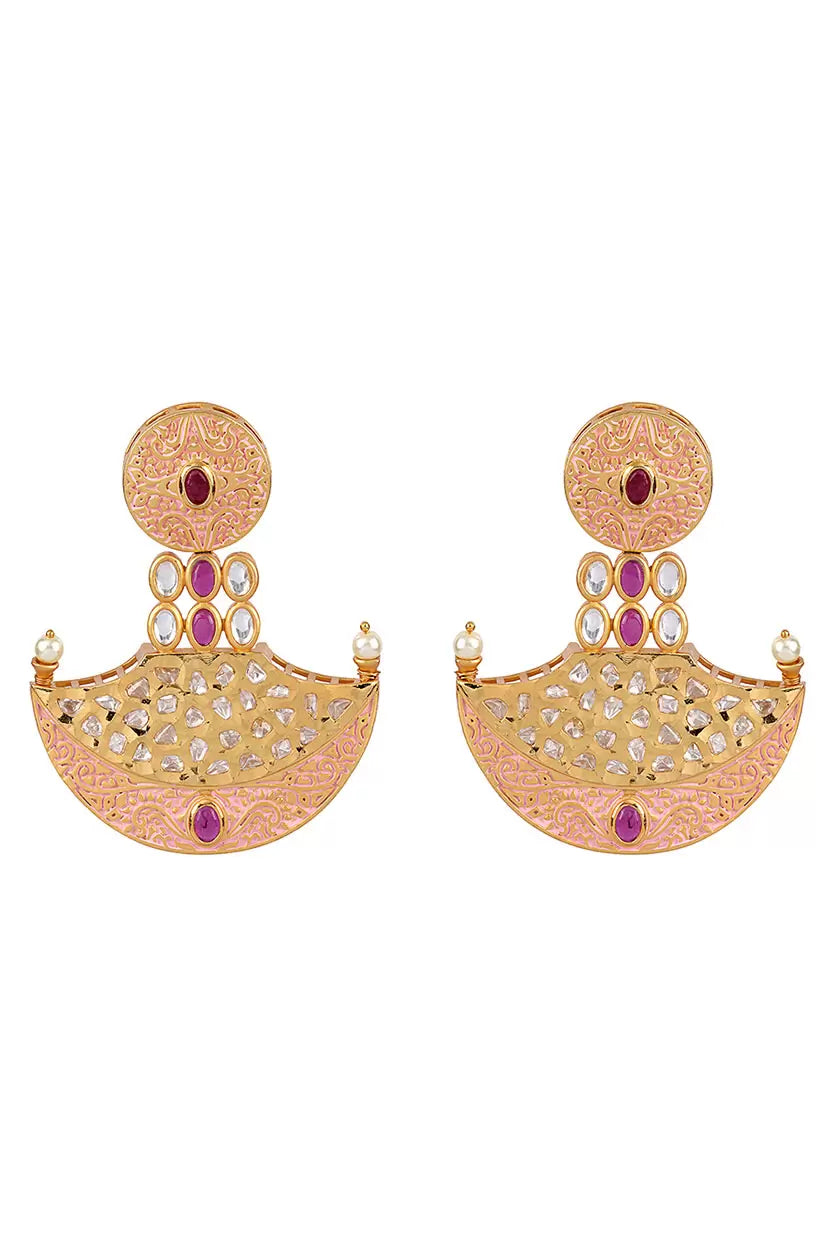 A closeup of earrings in gold and red stone from BenzerWorld ethnicwear store.