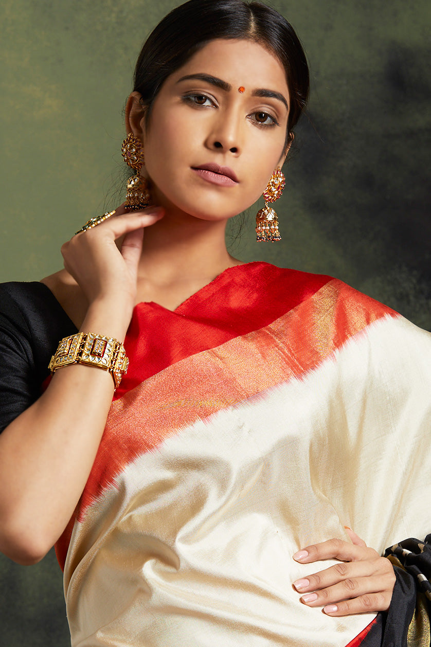 A closeup of a golden jadau bracelet from BenzerWorld ethnicwear store.