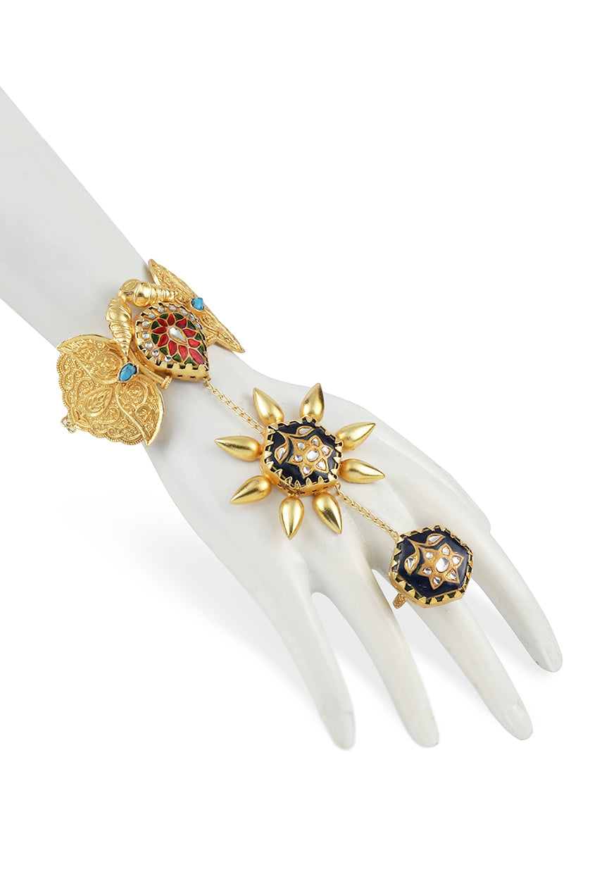 A closeup of metal hand chain with blue meenakari from BenzerWorld ethnicwear store.