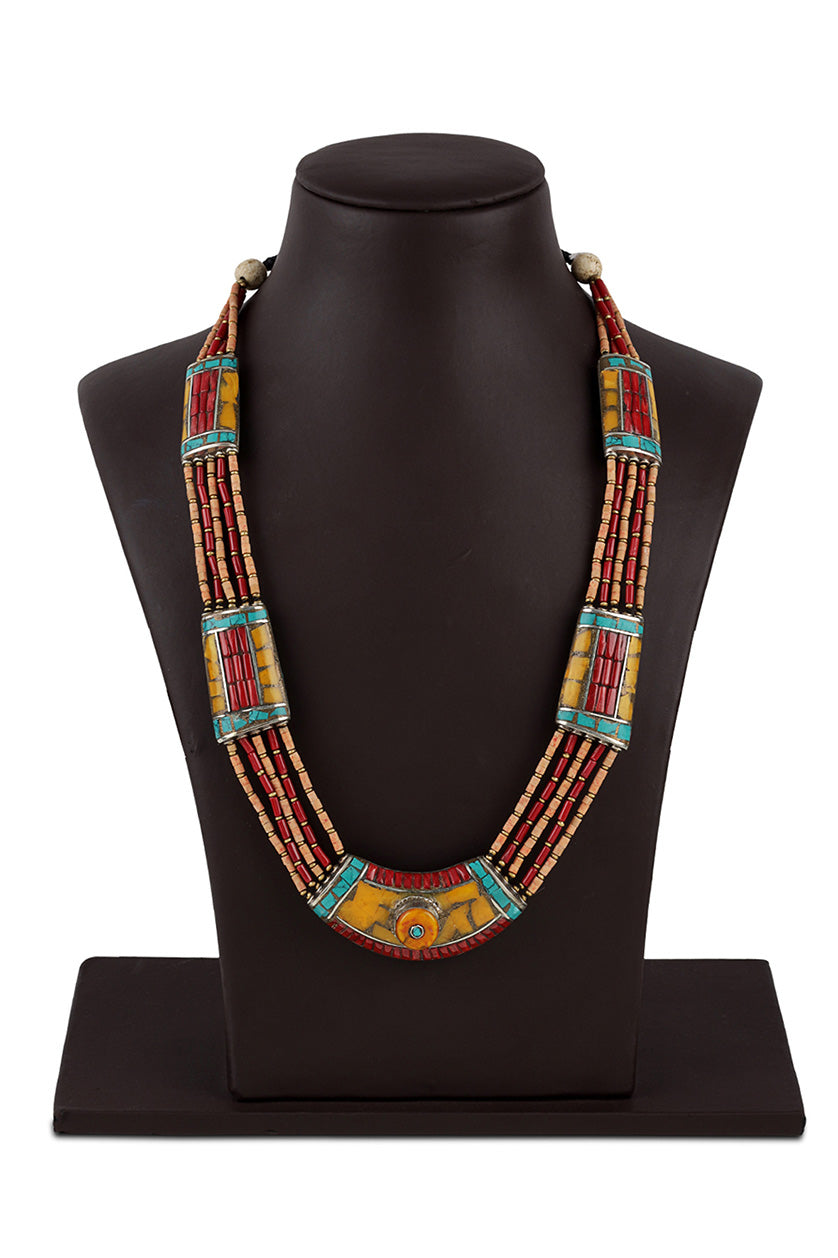 A closeup of a multicoloured necklace with a yellow stone pendant from BenzerWorld ethnicwear store.