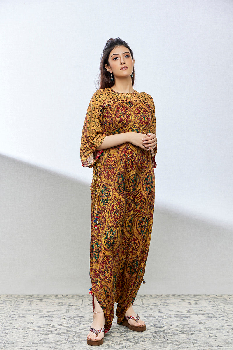 A woman poses in a mustard multicoloured georgette anarkali from BenzerWorld ethnicwear store, while looking ahead.