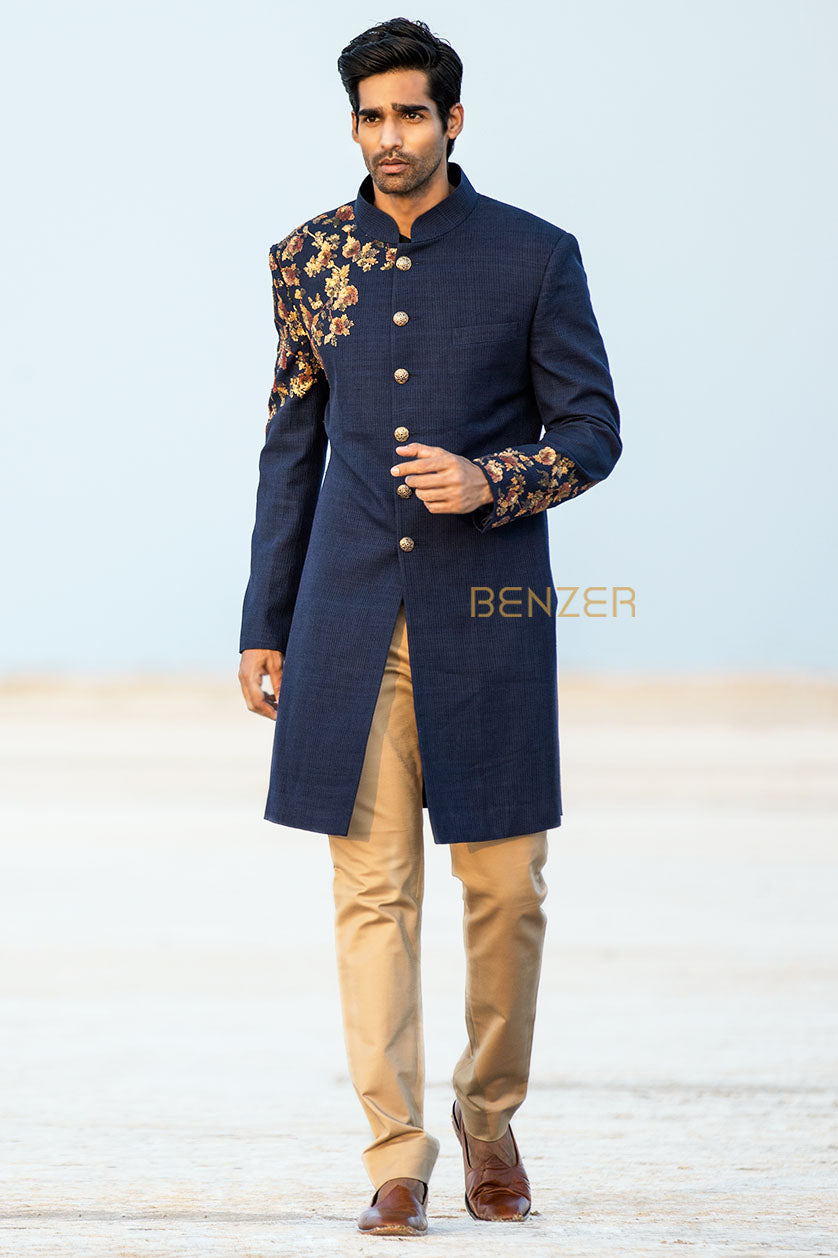 A man poses in a navy blue jute sangeet outfit from BenzerWorld ethnicwear store.