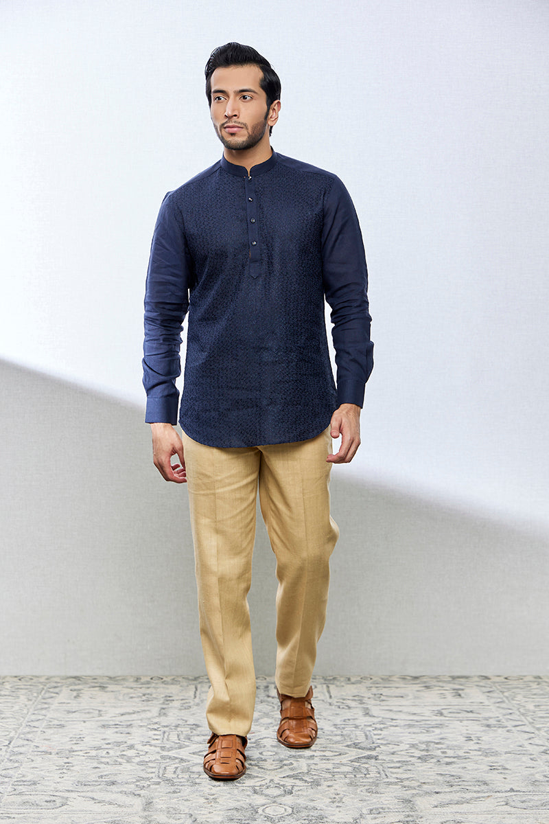 A man poses in a navy blue linen shirt from BenzerWorld ethnicwear store.