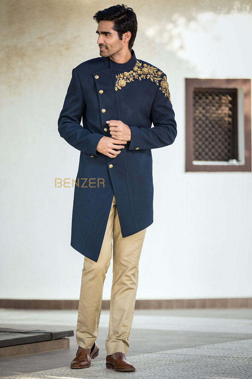 A man poses in a navy blue terrywool sangeet outfit from BenzerWorld ethnicwear store.