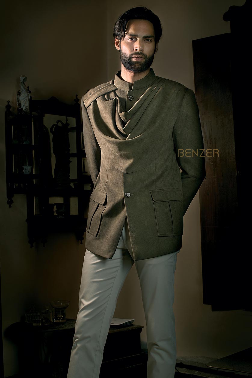 A man poses in a olive green suede drape bandgala from BenzerWorld ethnicwear store.