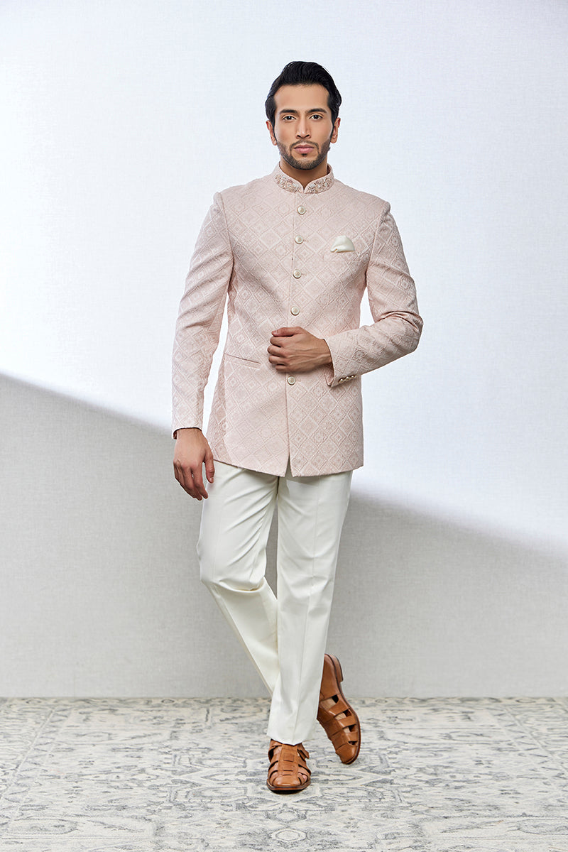 A man poses in a peach jacquard kurti from BenzerWorld ethnicwear store.