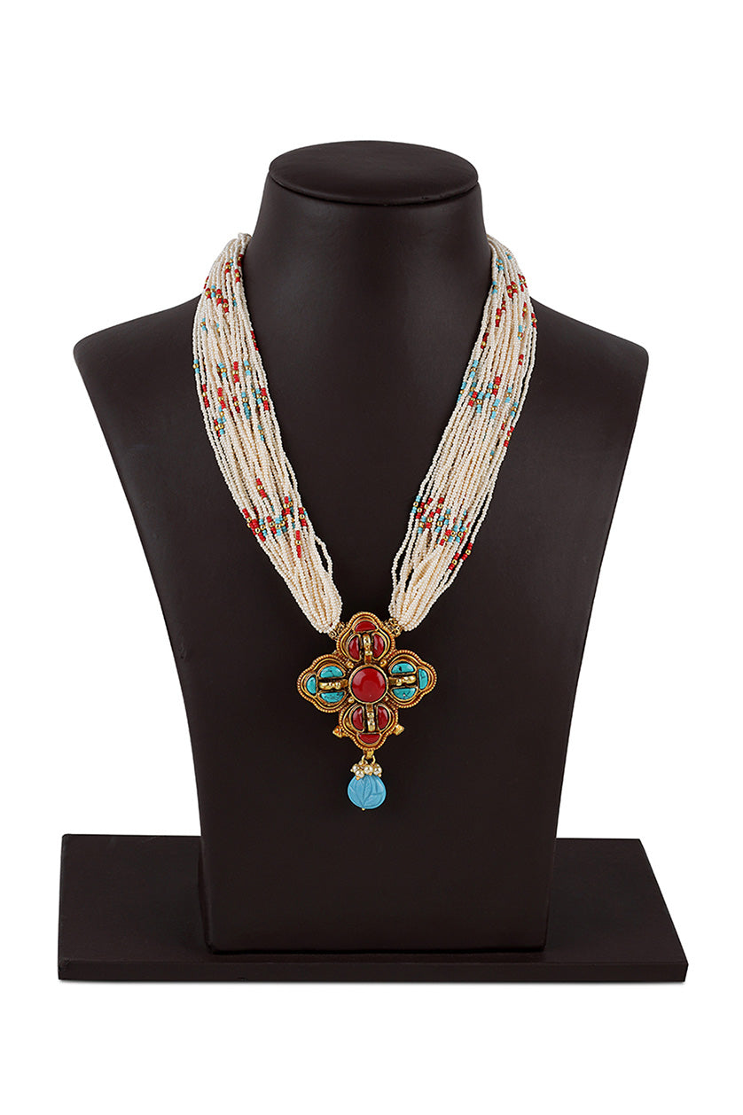 A closeup of a pendant necklace in plus shape from BenzerWorld ethnicwear store.