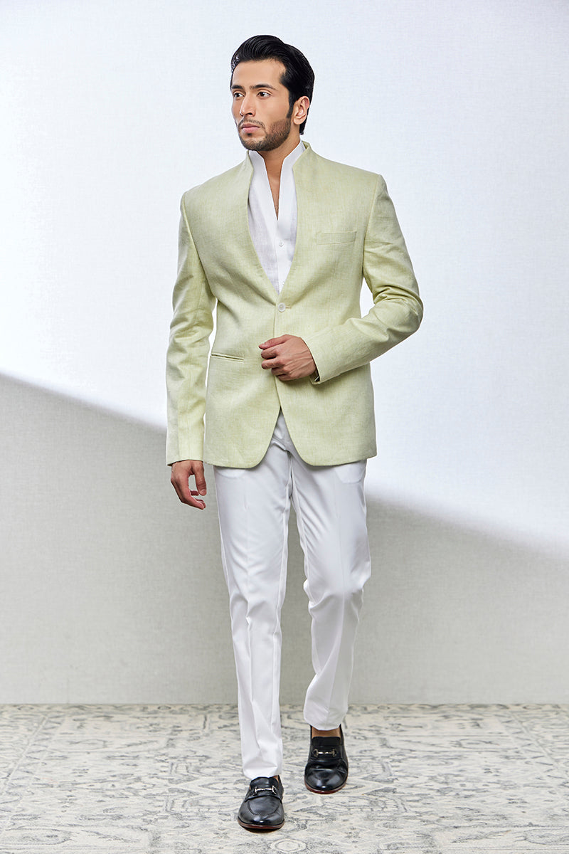 A man poses in a pista green jodhpuri suit from BenzerWorld ethnicwear store.