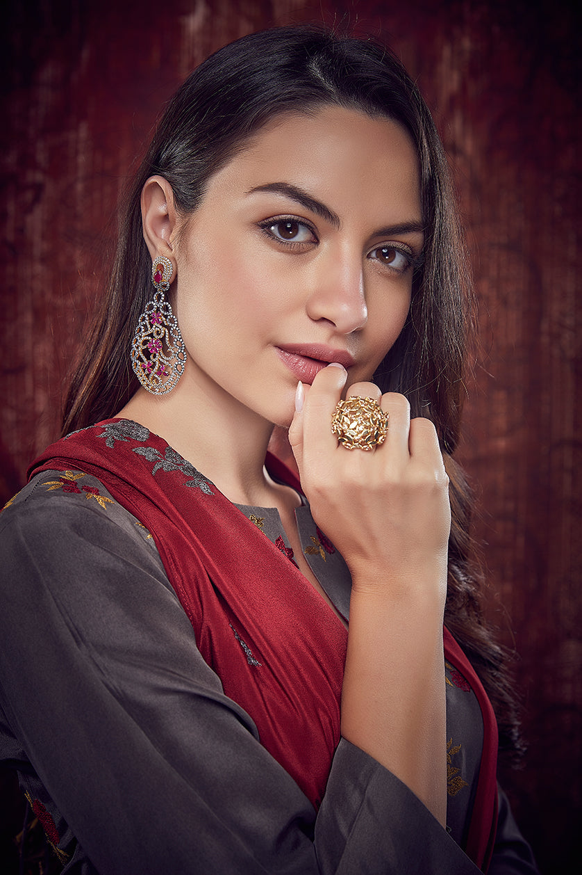 A closeup of semi-precious ruby-stone-studded earrings from BenzerWorld ethnicwear store.