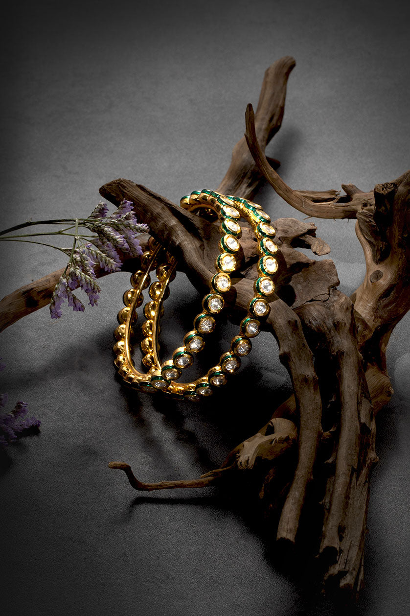 A closeup of single-line oval-shaped vilandi bangles from BenzerWorld ethnicwear store.