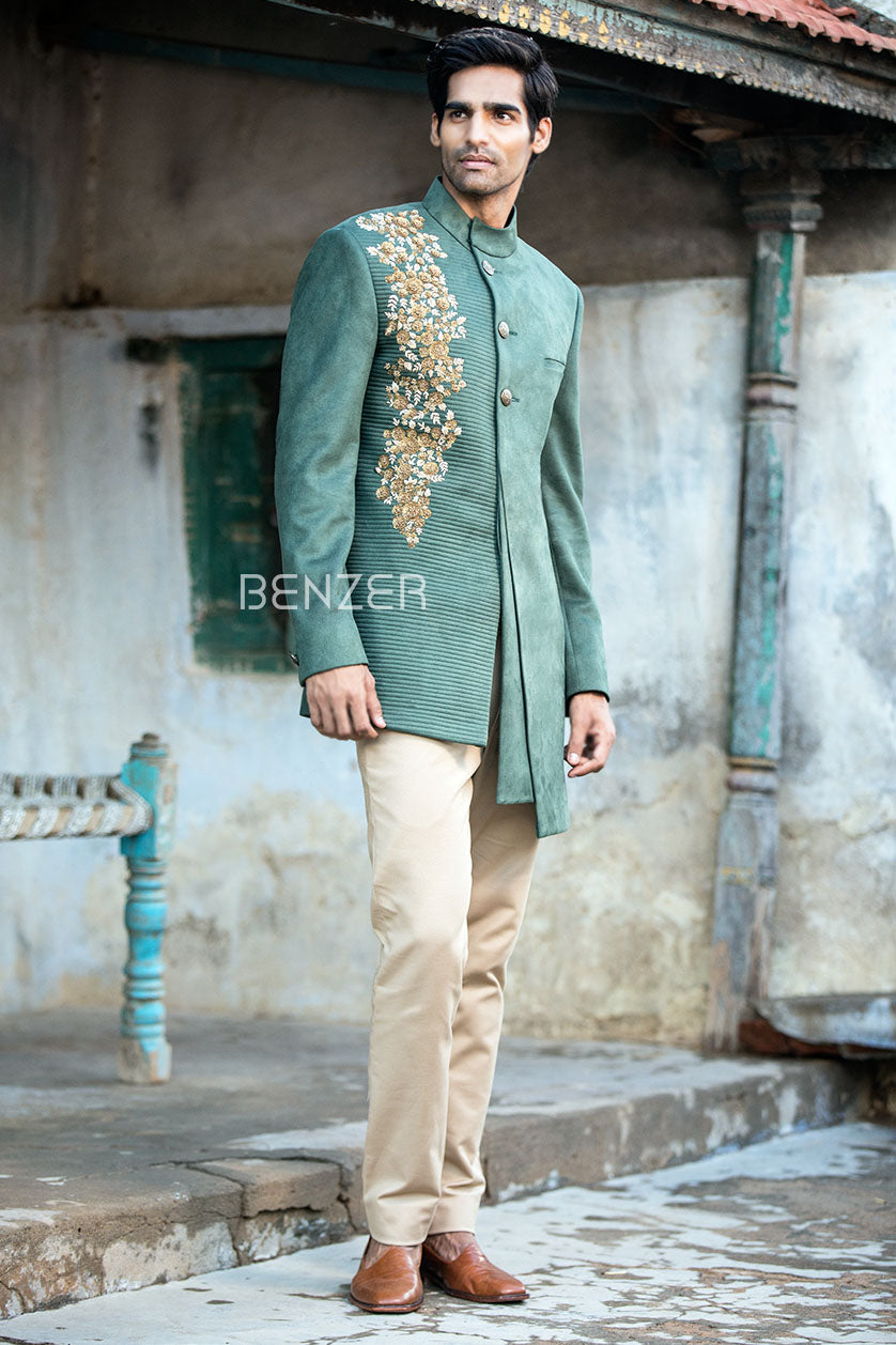 A man poses in a teal green suede cocktail outfit from BenzerWorld ethnicwear store.