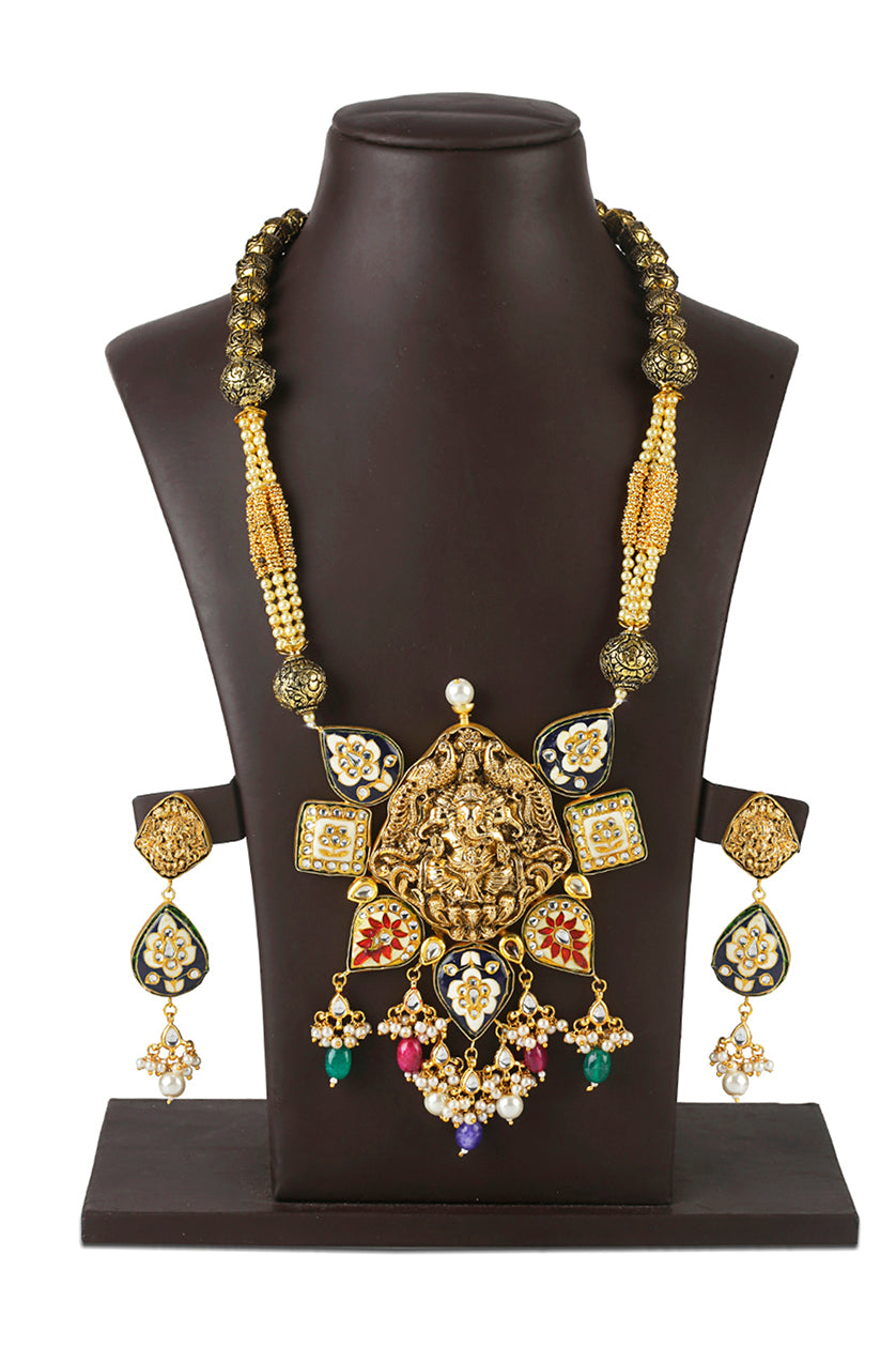 A closeup of temple jewellery with saraswati pendant from BenzerWorld ethnicwear store.