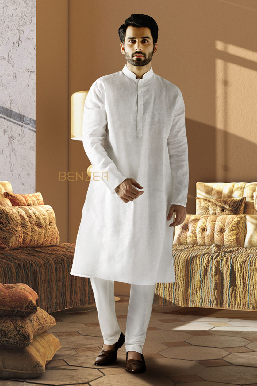 A man poses in a white linen plain kurta set from BenzerWorld ethnicwear store.