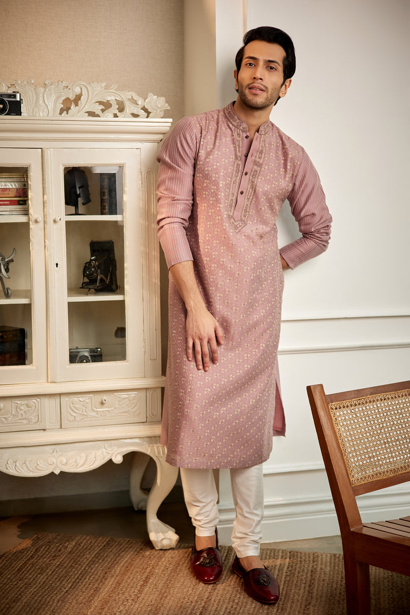 A man in a mauve chanderi silk kurta set from BenzerWorld ethnicwear store poses for the camera.