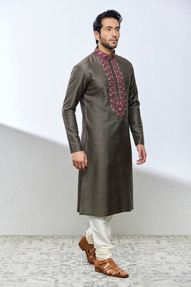 A man poses in a brown munga silk kurta set from BenzerWorld ethnicwear store.