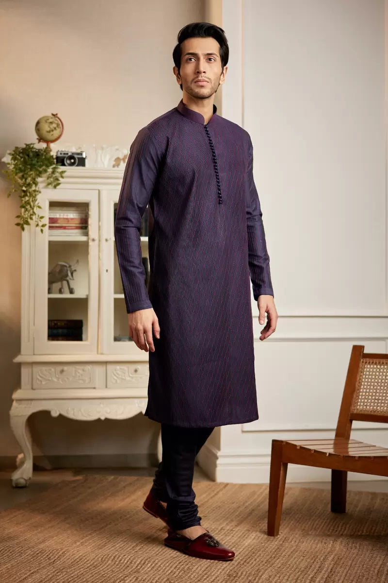 A man in a navy blue cotton silk kurta set from BenzerWorld ethnicwear store poses for the camera.